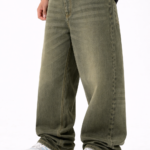 Men wearing olive green oversized fit denim jeans with relaxed streetwear style and casual sneakers.